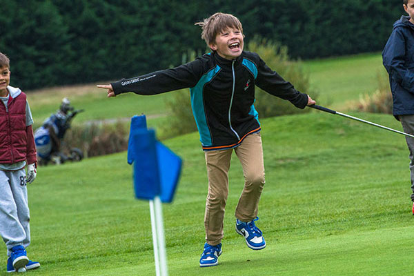 junior golf boy happy