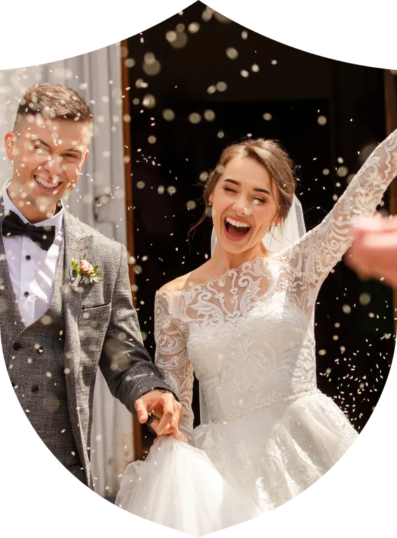 Man and woman celebrating their wedding in kent with confetti and holding hands