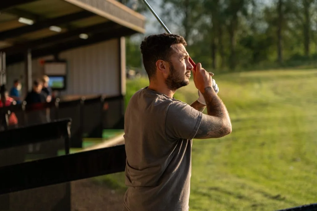 Man taking shot on the driving range at Birchwood Park