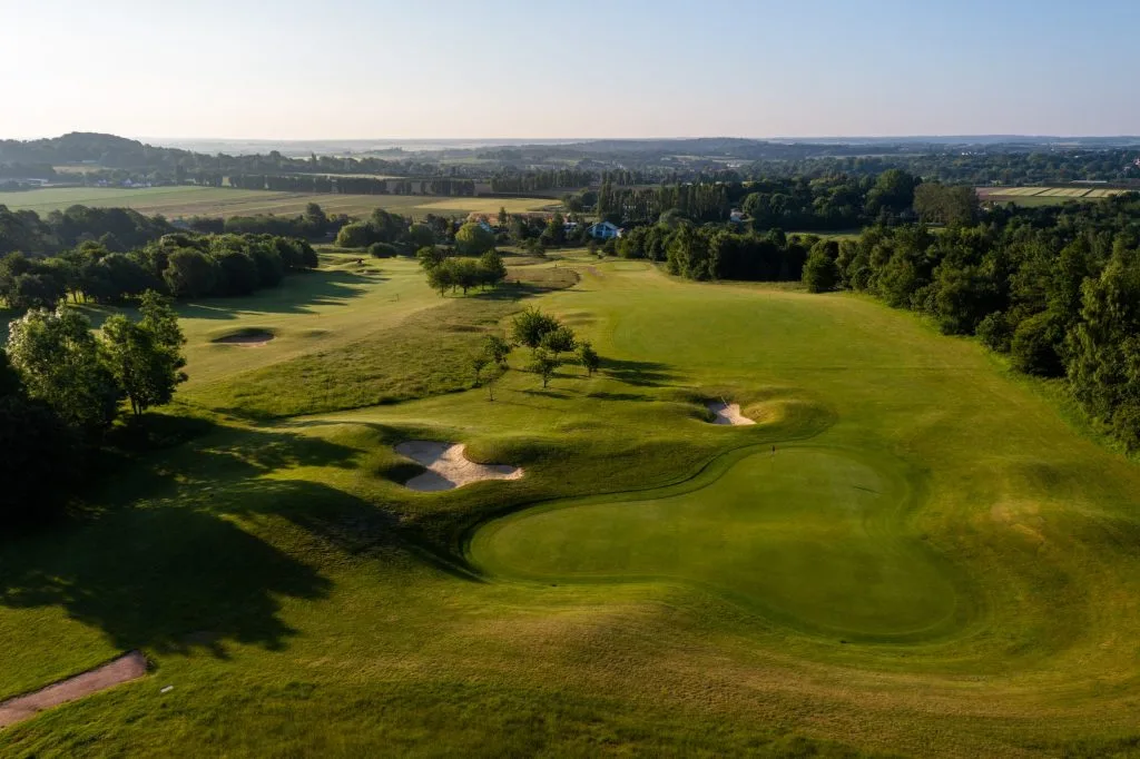 aerial shot of golf course in kent at birchwood park with luscious grass and golf holes