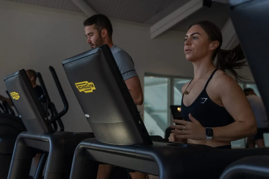 Woman and man on Technogym treadmill exercising at gym in dartford