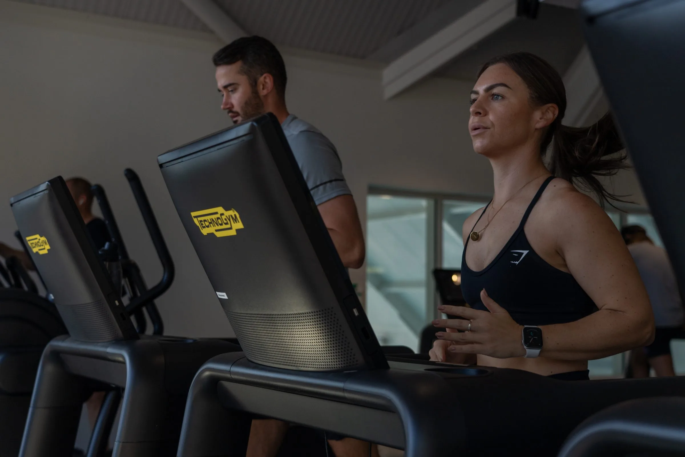 Woman and man on Technogym treadmill exercising at gym in dartford