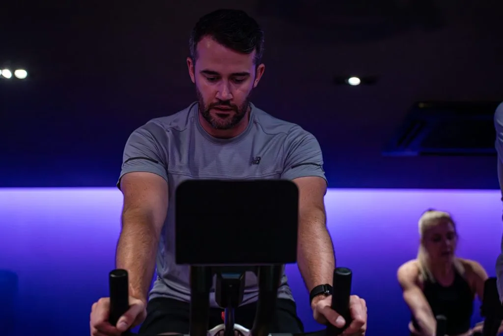 Man on spin bike, exercising at gym in dartford