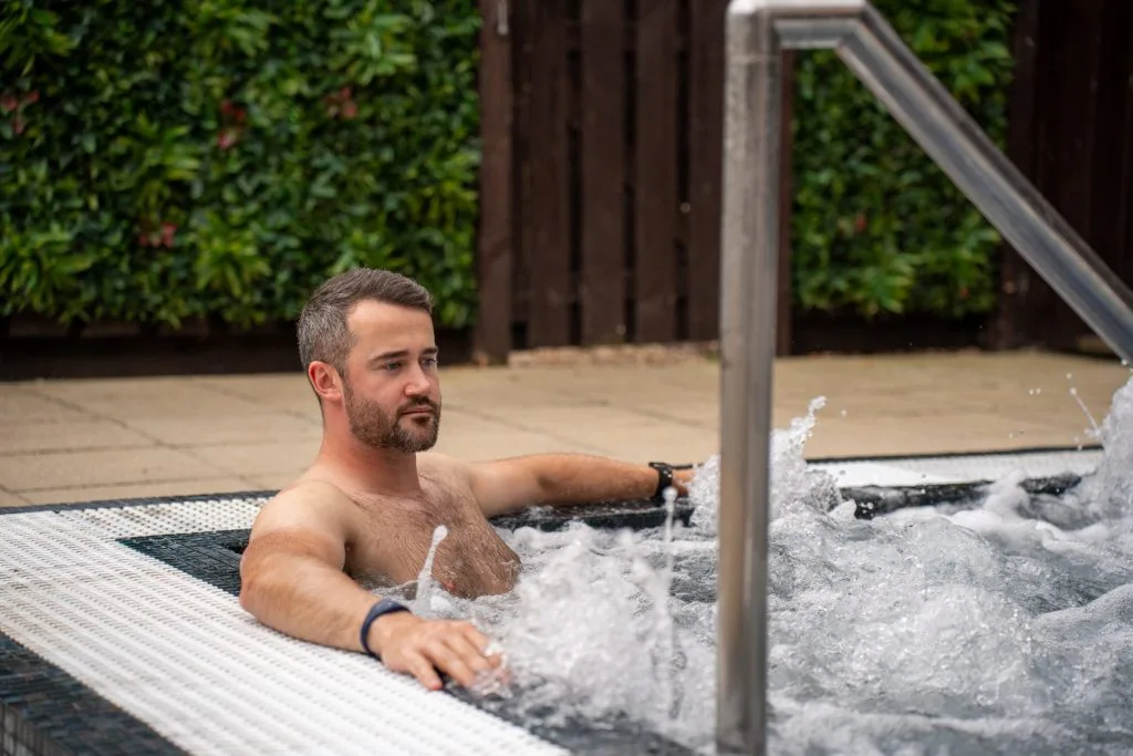 Man relaxing in outdoor hot tub in kent