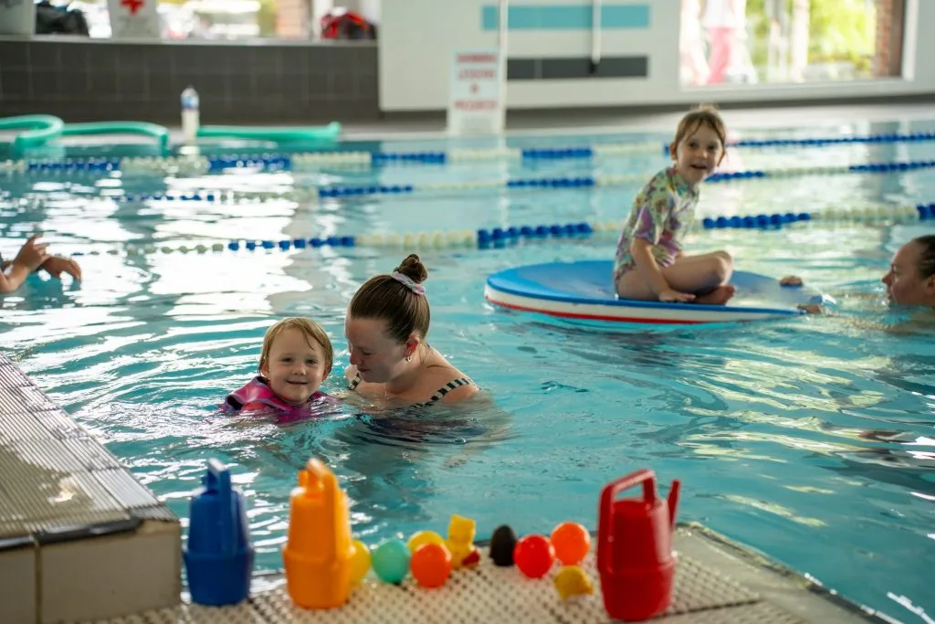 Woman in pool with child at swimming pool in swanley