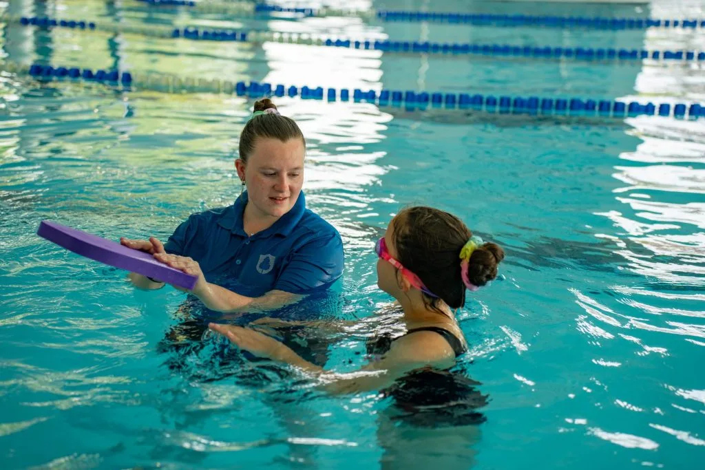 Woman giving a swimming lesson in pool in dartford