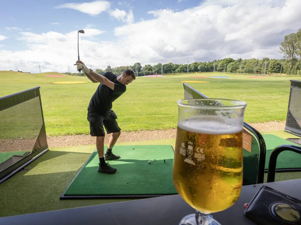 golfer in backswing at trackman driving range in kent