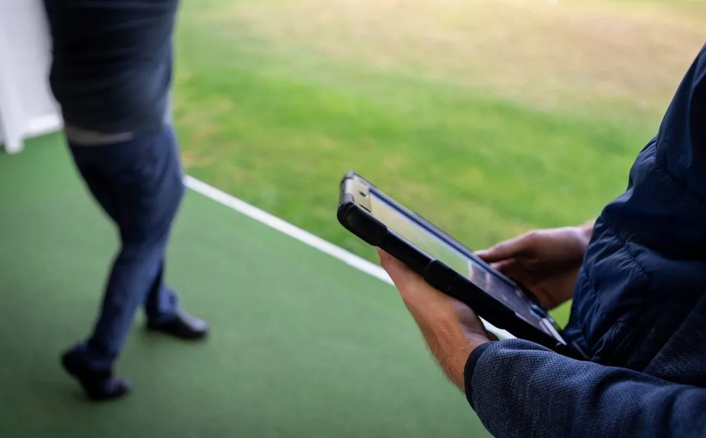 Person holding a tablet during a custom fit session in kent